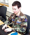 Cadet Chief Master Sergeant Kevin Pinerio (NY033) works on a laptop during a CyberPatriot class.