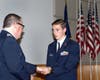 Major Phil Feldman presents the Red Service ribbon  to Cadet Chief Master Sergeant Nick Ahern.