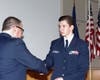 Major Phil Feldman presents the Red Service ribbon  to Cadet Master Sergeant Nick De Benedictis.
