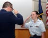 Cadet Master Sergeant Maggie Mahoney salutes Major Phil Feldman after receiving the Red Service ribbon.