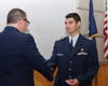 Major Phil Feldman congratulates Cadet Second Lieutenant Diego Gonzalez for receiving the Red Service ribbon