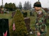 Cadet Senior Airman Michael Pereira salutes after placing a wreath on a veterans grave in the Raymond Hill Cemetery.