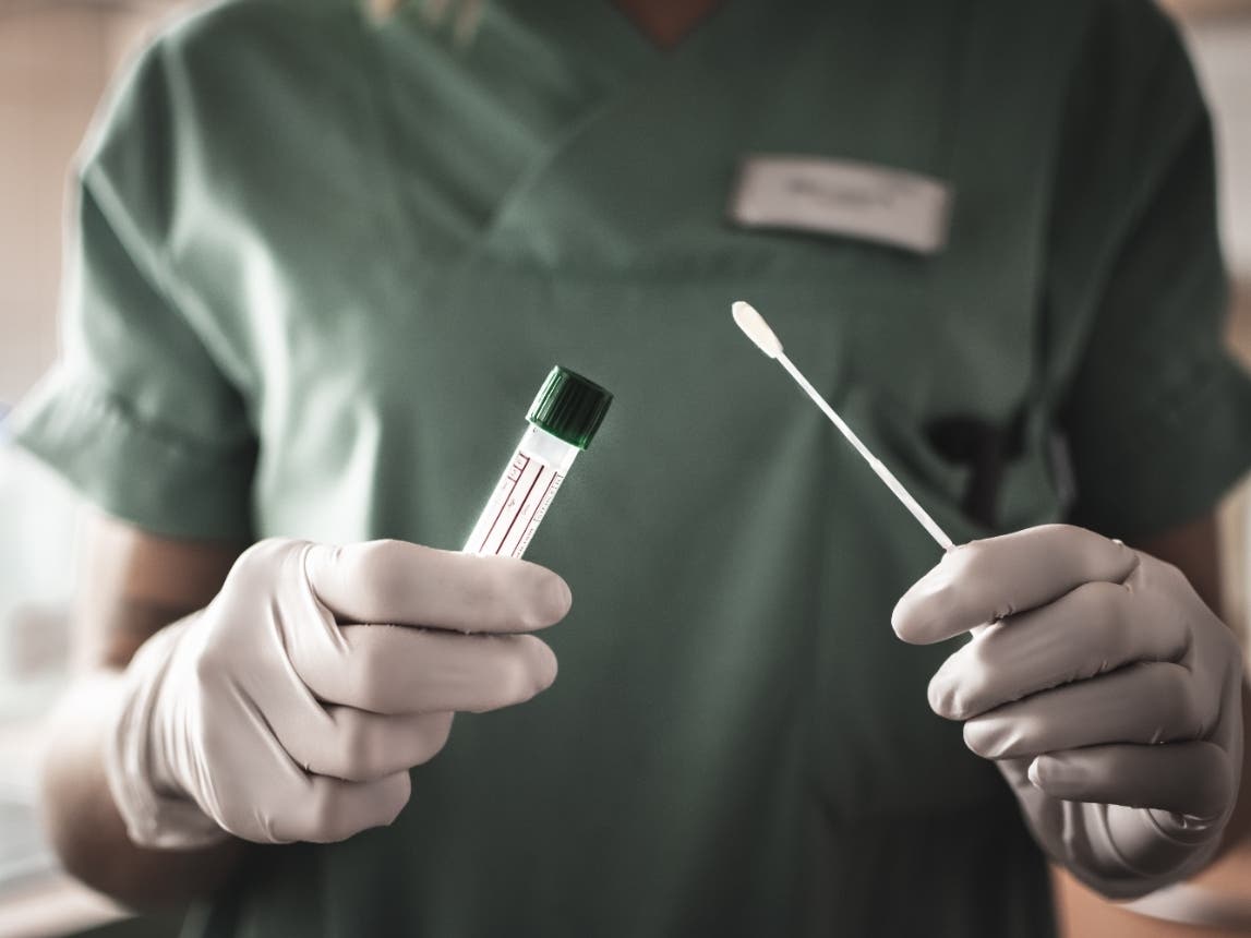 nurse holds a swab for the coronavirus / COVID19 test