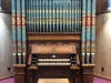 The rebuilt 1892 Woodberry & Harris organ features decorative painted pipes that were a typical design of the period.