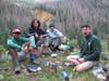 Scouts preparing dinner with backpacking stoves and dehydrated food.  