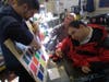 Arts Access artist Paul works with his facilitator to choose the next color for his painting