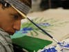 Artist Brad uses adaptive equipment to create a painting