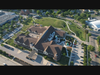 An aerial view of the vibrant St. Ann Center's Bucyrus Campus at 24th and North, showcasing the bandshell (upper left); innovative Intergenerational Playgarden (right courtyard); and raised garden beds (upper right).