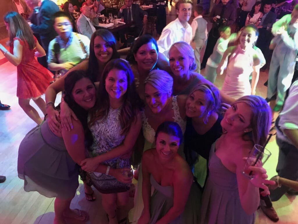 The bride, pictured with friends. The crashers can be seen in the top right hand corner.