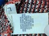 A look at the tag on Jane Seneca Doe's sweater. 