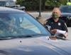 School Resource Officer Ted Morley helps distribute meals to Westlake seniors. 