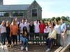 Mark Dombroski’s Waldron Mercy Academy classmates gather around a bench installed on the playground in his honor.