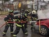 Firefighters from the Merion Fire Company of Ardmore battle a car fire Friday morning.
