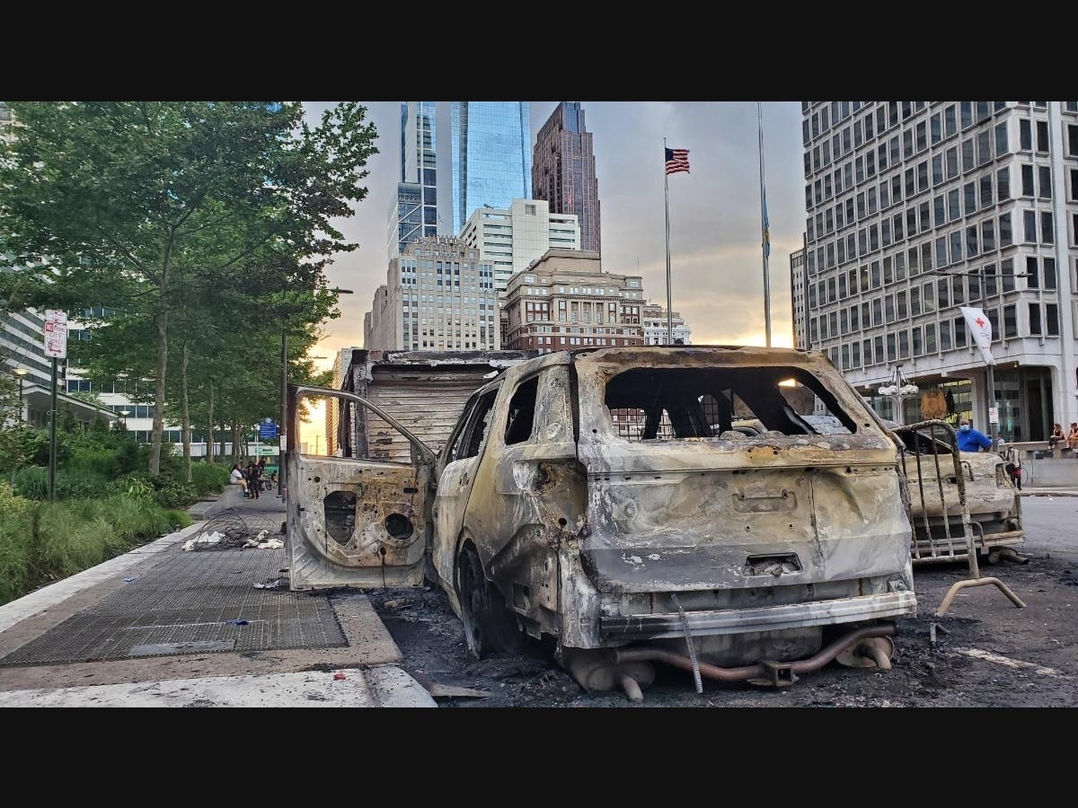 Two Philadelphia Police vehicles sit burned following protests in late May.