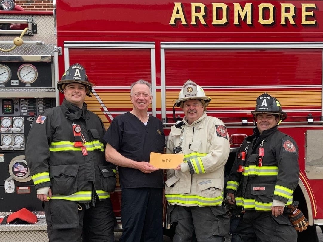 Rotary Chairperson Dr. Jim Hall presents Chief Tom Hayden and firefighters Arman Force and Scott Russell.