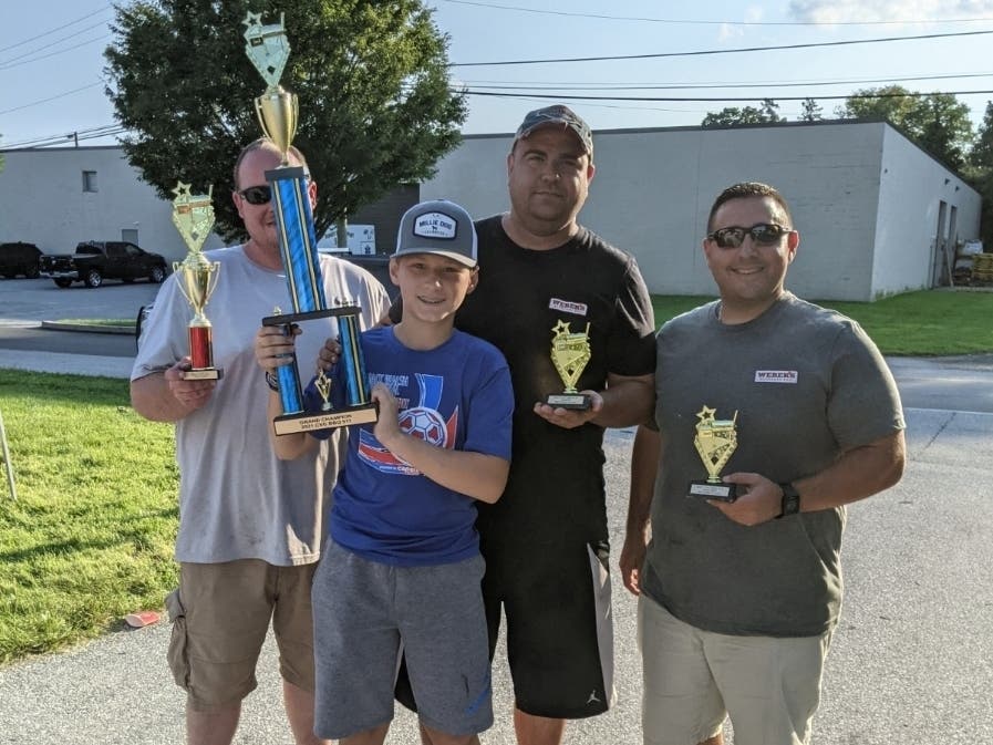 Weber’s Backyard BBQ cooking for the Lower Merion Fire Department – Grand Champions of the Event. From left to right are John, Ryan, Rob Weber and Ed.