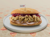 The Phillies Gobbler features in-house carved turkey, homemade stuffing, and cranberry sage aioli on an Amoroso long roll with a side of turkey gravy.