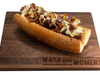The new 24stK sandwich features a smoked beef rib topped with truffle cheese sauce, caramelized onions, and A.1. demi sauce and served on a Liscio Bakery roll.