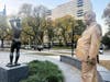 A statue of former President Donald Trump appeared behind the nude sculpture in Philadelphia's Maja Park.