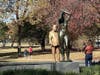 A statue of former President Donald Trump appeared behind the nude sculpture in Philadelphia's Maja Park.