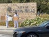 Tai Ji Men dizi hold signs on a sidewalk in Chino Hills to denounce the Taiwanese government’s persecution of Tai Ji Men on August 16, 2020.