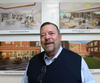 Real estate developer Gary Richetelli stands in front of artist renderings of the remodeled cafeteria at Notre Dame, which will be named in honor of the Gary Richetelli '65 Family following his donation of $1.01 million to the school renovation project. 