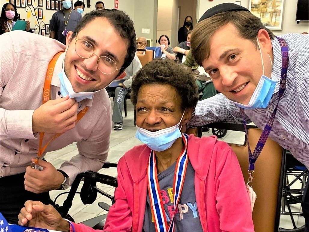 An All Choked Up U.S. Army Veteran Denise Howard Receives Her Certificate as She is Surrounded by Assistant Administrator Neil Rosenberg on left and Administrator Nate Goldman is on right.