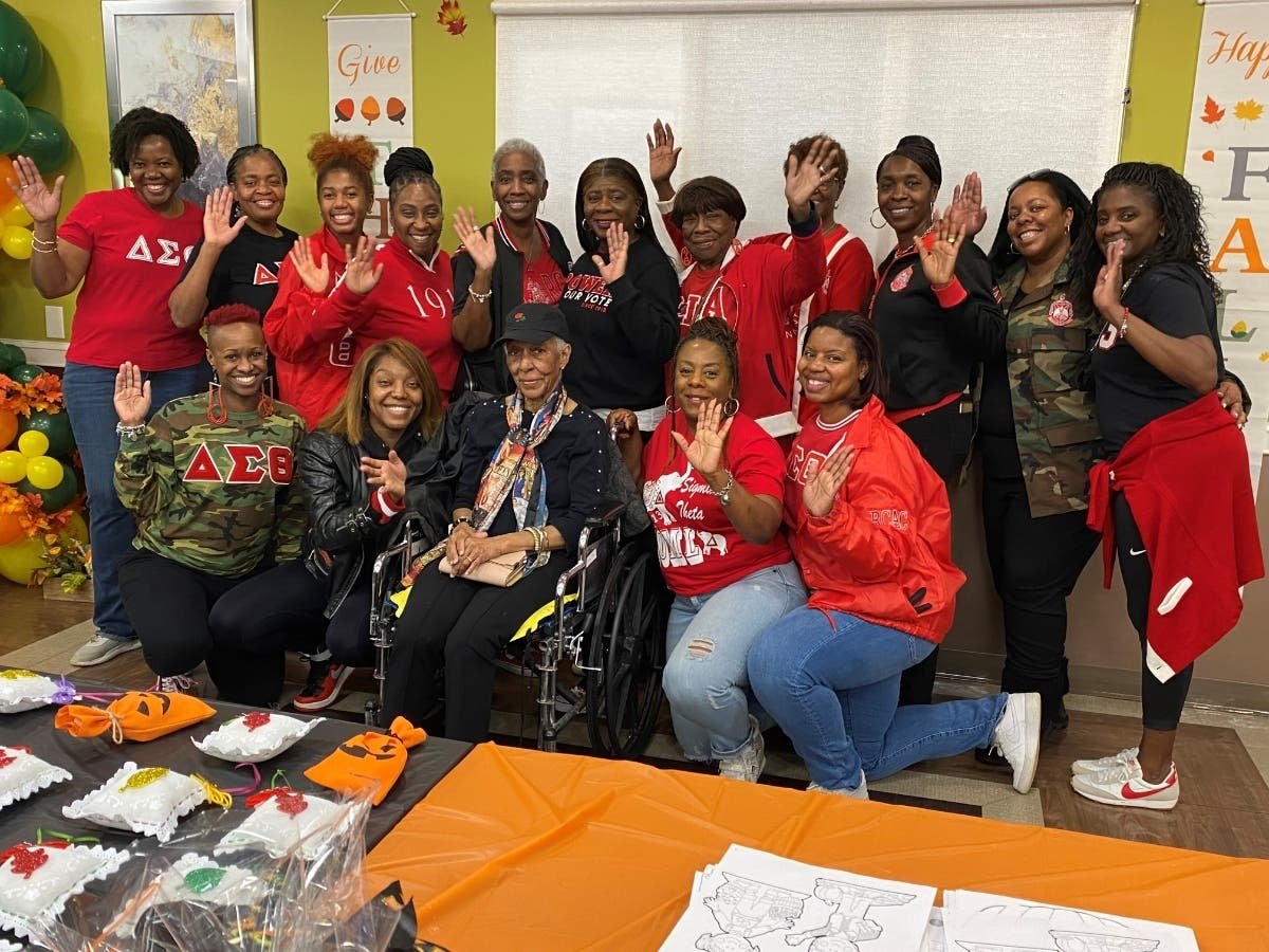 Ms. Merle George (sitting bottom middle), is surrounded by the sorority sisters of the Rockland County Alumnae Chapter of the Delta Sigma Theta Sorority. Directly above Ms. George is Dr. Matthews, just left of President Toutebon