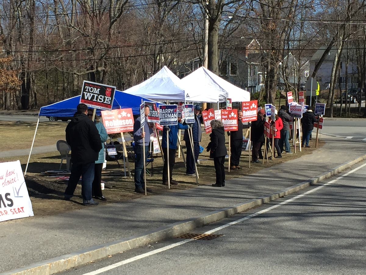 Candidates and their supporters greeted voters heading into the RMHS fieldhouse.