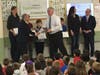 Batchelder principal Sean Killeen accepts a plaque from Toshiba's Mark Di Derri.