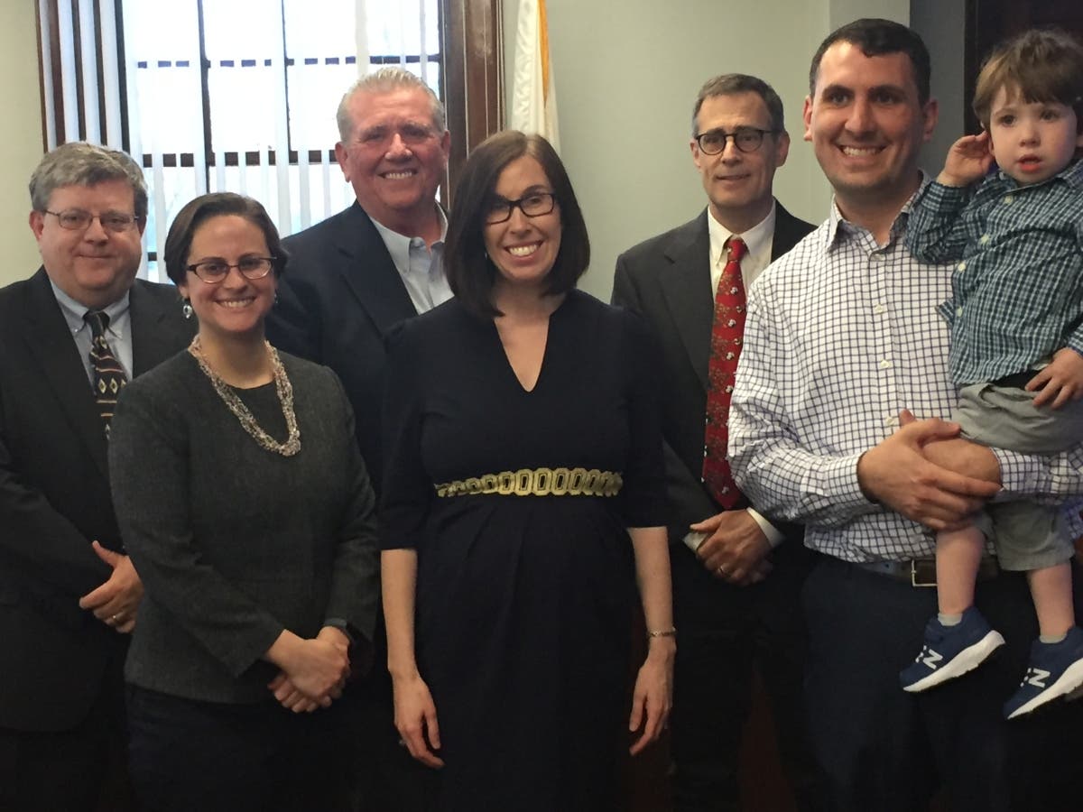 Joined by her husband Ryan and son Michael, Anne Landry, is welcomed to the Select Board Tuesday.