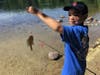 Adam Aitbourezgue, age 7, holds up the fish he caught during the 20th annual Fishing Derby. 