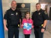 Left to right: School Resource Officer Ed Fucarile, fifth grade student Grace Newborn and Officer Luc Bourgeois. Newborn