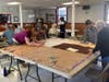 Working with 7 foot x 14 foot "shells," volunteers use donated blankets to build the cozy sleeping bags.