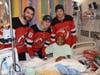 From left to right: Devils forwards Kyle Palmieri, Jack Hughes and defenseman Sami Vatanen visit 10-year-old patient Nehemiah Garrett on Tuesday afternoon