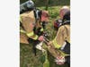 Eastside firefighters work to save a cat who was pulled from a burning home on Thursday. 