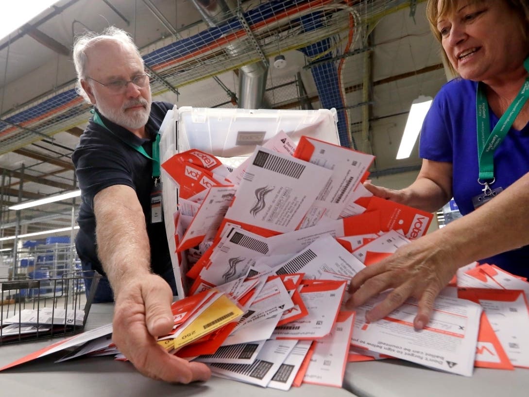 King County election workers Mark Bezanson and Julie Olson at work on Election Day 2018.