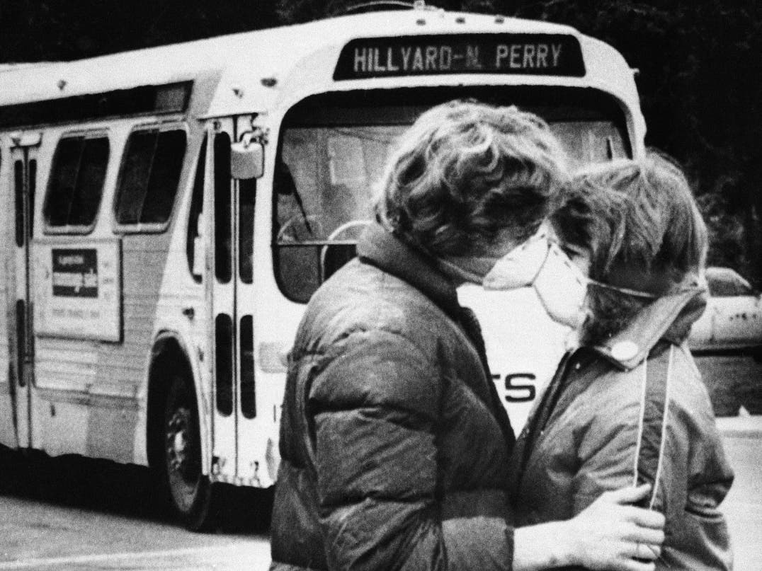 Heidi Havens, 15, kisses Allen Troup, 16, before boarding a Spokane bus on May 27, 1980