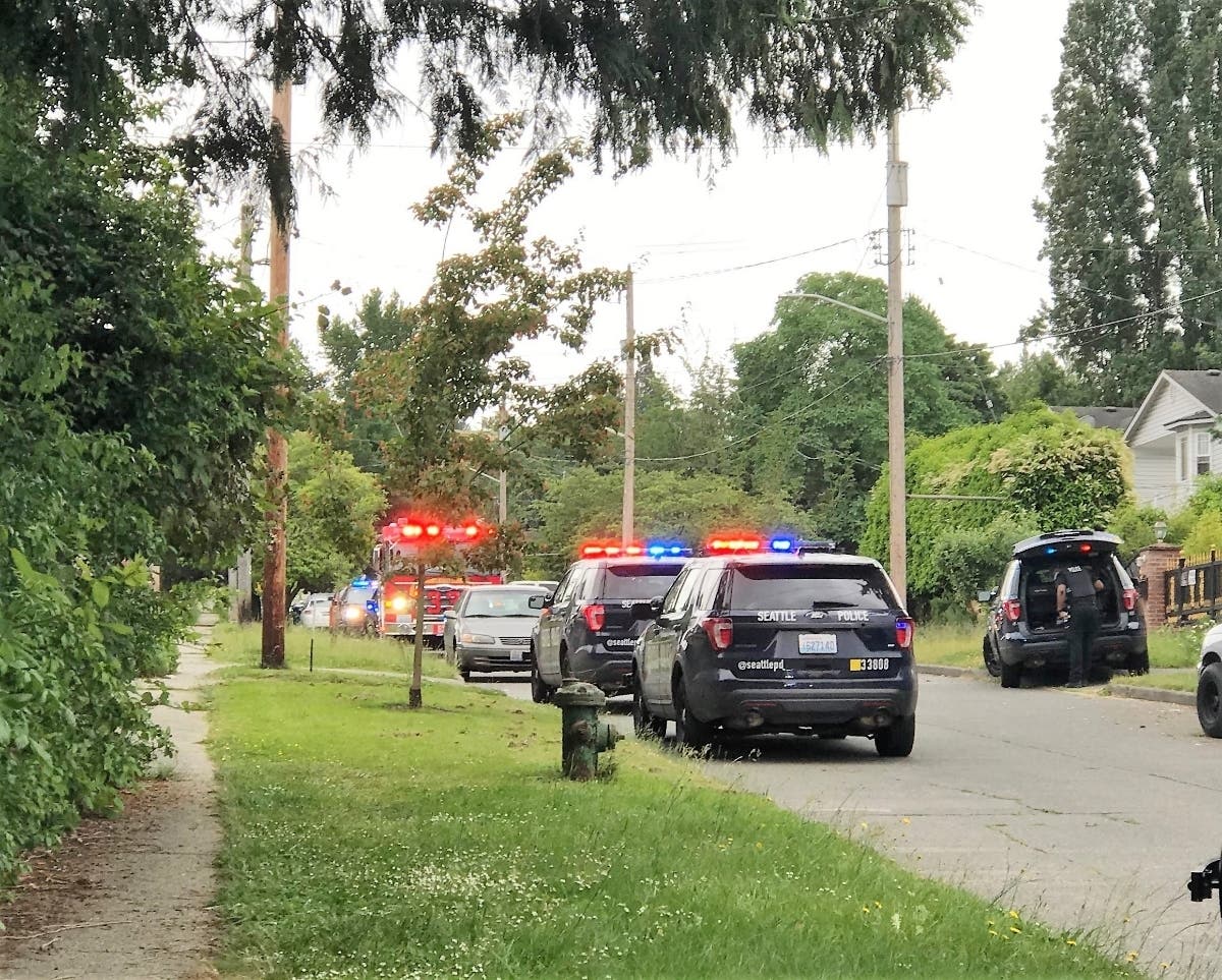 Seattle police outside a home near 57th Avenue South and South Pilgrim Street on Monday afternoon.