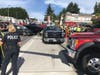 A woman sitting at a bus stop was hit by a truck and trapped underneath Wednesday afternoon in Bellevue. 