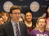 Gonzalez standing behind Attorney General Bob Ferguson at a February press conference. 