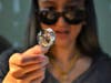 Schafer shows small details she's added to the glass. 