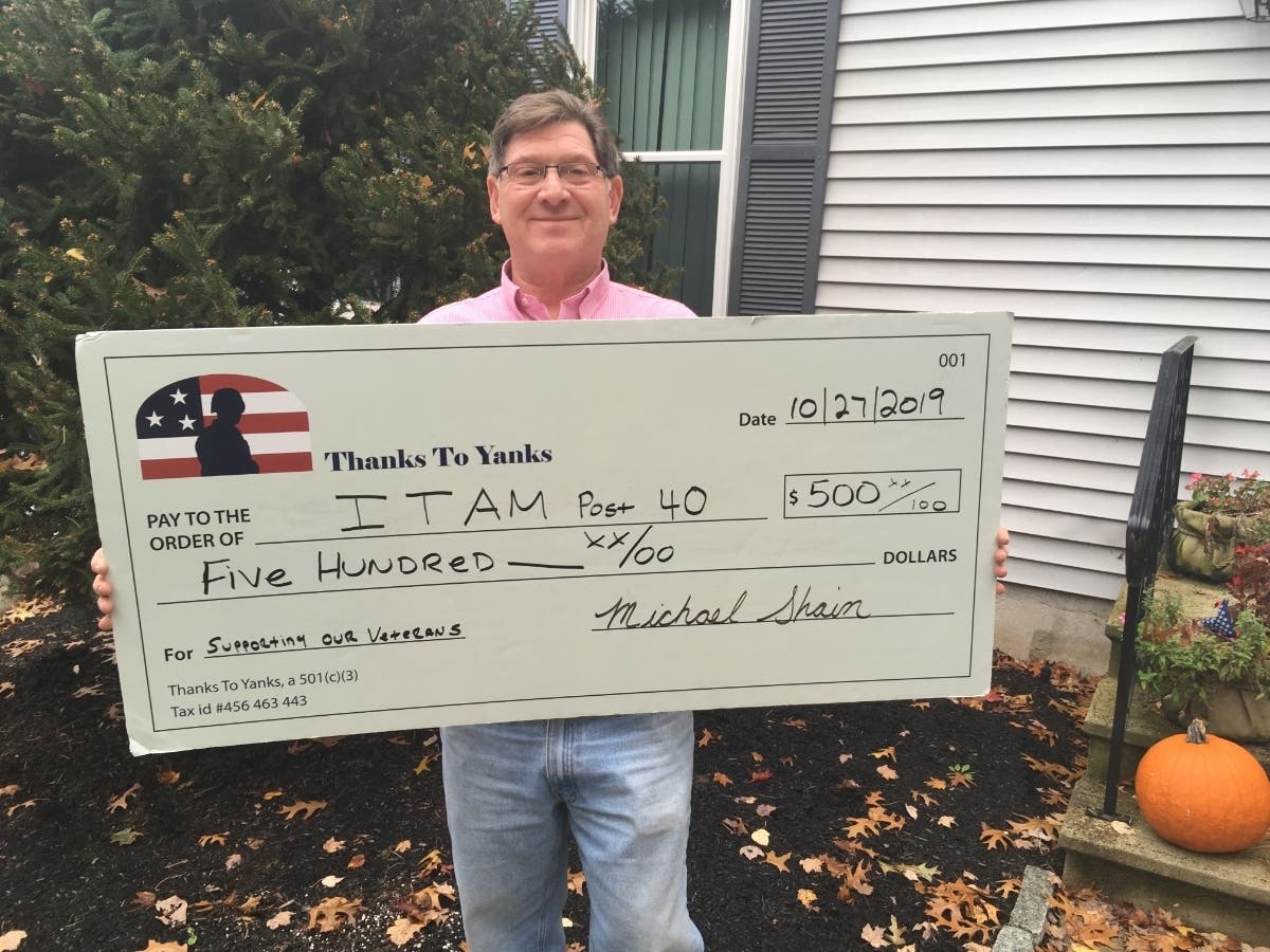 Thanks To Yanks founder Michael Shain with a check for the Italian American War Veterans Post 40 in Milford. 