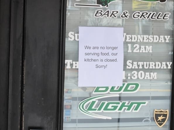 A sign on the front door of a Worcester bar along Green Street. 