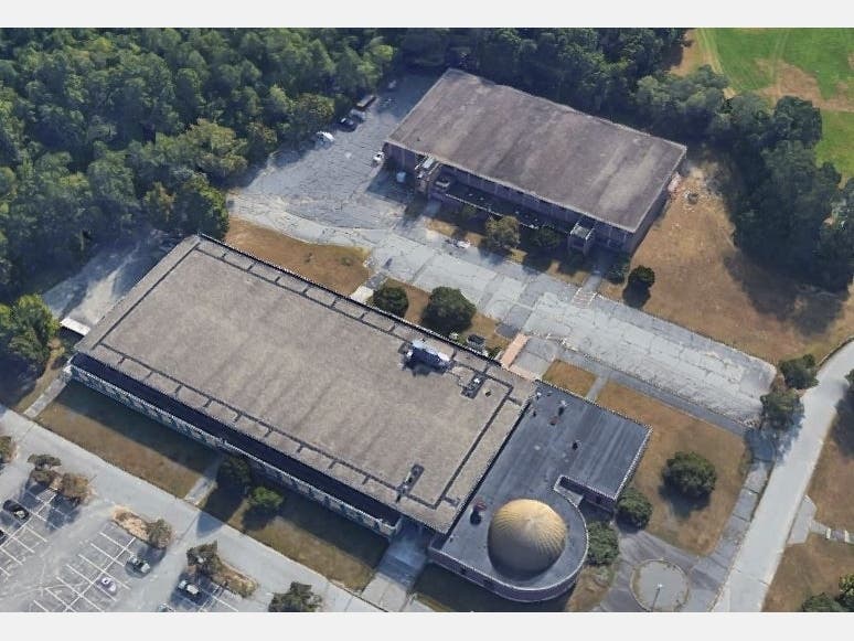 The Landry Arena at Fitchburg State University, where refrigerator trucks have been staged as overflow storage for human remains.