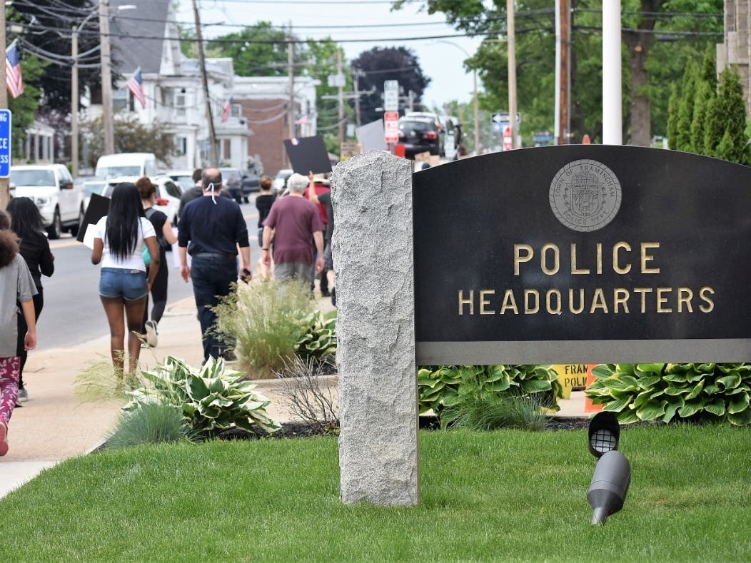 Black Lives Matter demonstrators pass by the Framingham police headquarters during a June 3 march. 