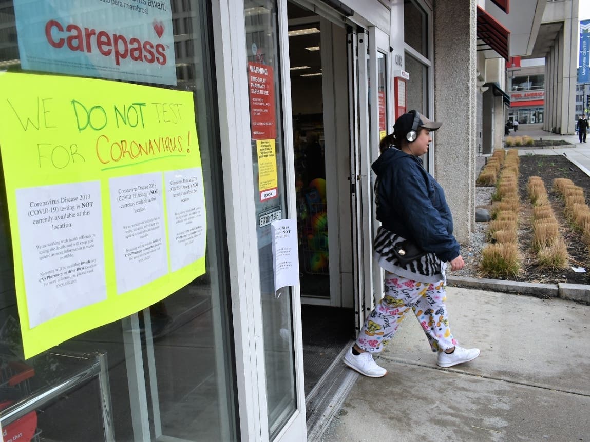 A woman exits the Front Street CVS in Worcester on March 17. 