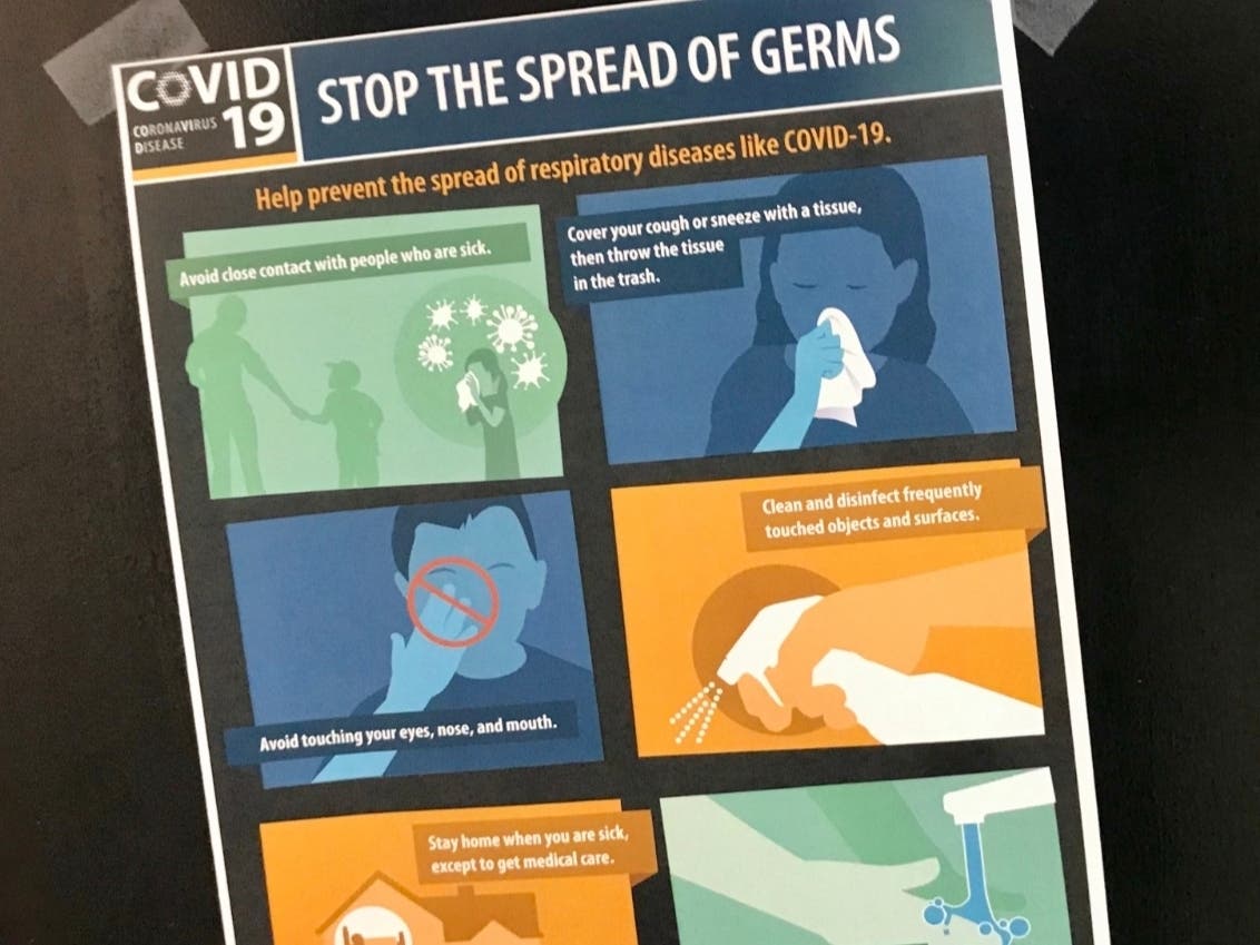 A sign taped to a door at Framingham's Memorial Building on March 6 explains how to avoid coronavirus.