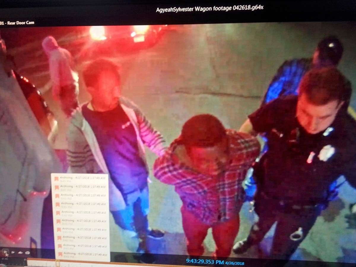 Sylvester Agyeah (center) was charged with interfering with a police officer and disorderly conduct, among other charges.