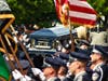 The casket of Worcester Officer Enmanuel "Manny" Familia being taken inside St. John's Church for a funeral Thursday morning. 